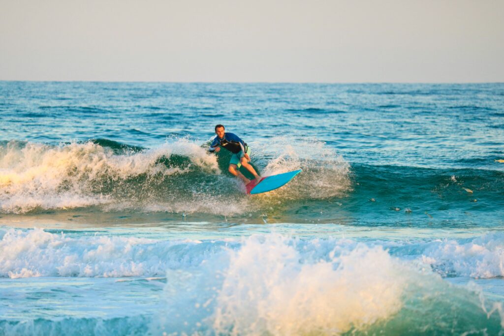 Surfer riding a wave at Bondi Beach, highlighting the popular surfing activity that draws enthusiasts of all skill levels to this iconic spot.